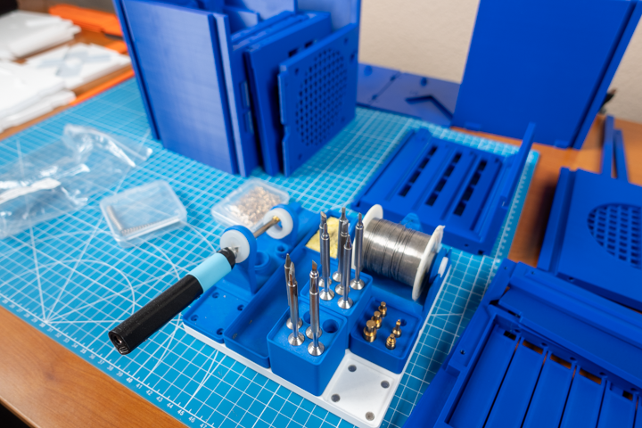 Preparing to use the soldering iron to put in all the heat-press inserts.